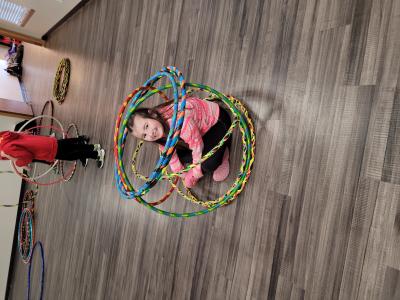 Child inside hula hoop structure